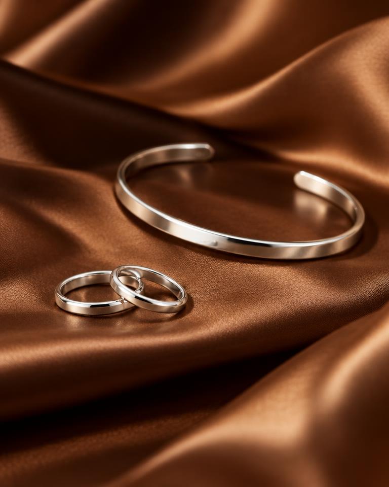Platinum jewellery photographed in warm brown and gold tones